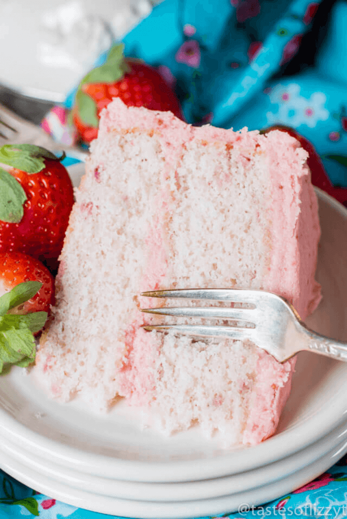 A close up of a piece of cake on a plate, with Strawberry cake