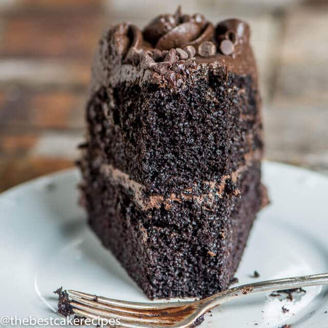 A close up of a piece of chocolate cake on a plate, with Dark chocolate and Buttercream