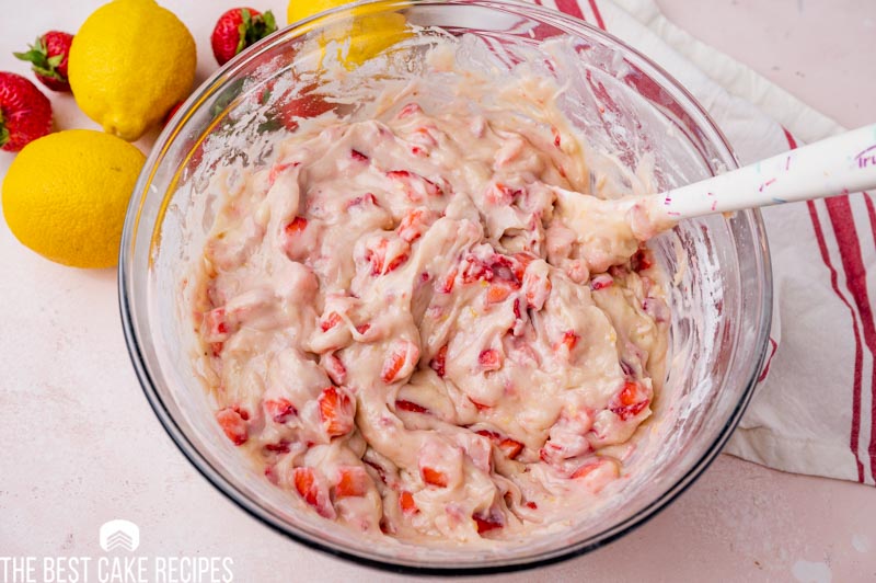 diced strawberries in cake batter in a bowl