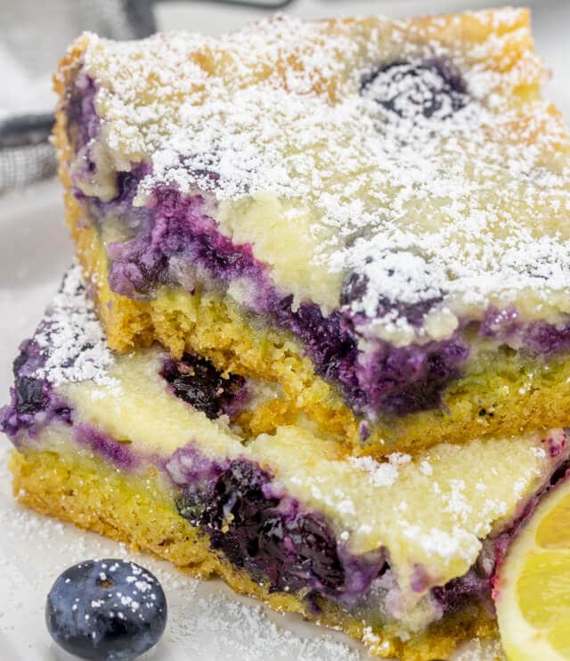 Only 10 minutes prep and this Gooey Blueberry Lemon Butter Cake will be baking! Semi-homemade dessert recipe with fresh blueberries and a sprinkling of powdered sugar.