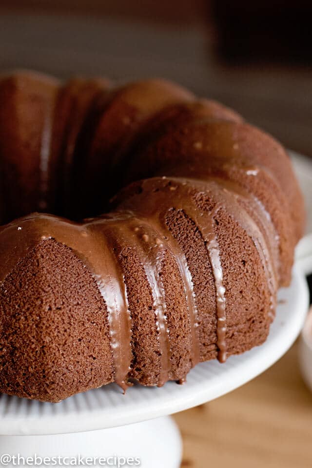 A close up of a chocolate bundt cake with glaze