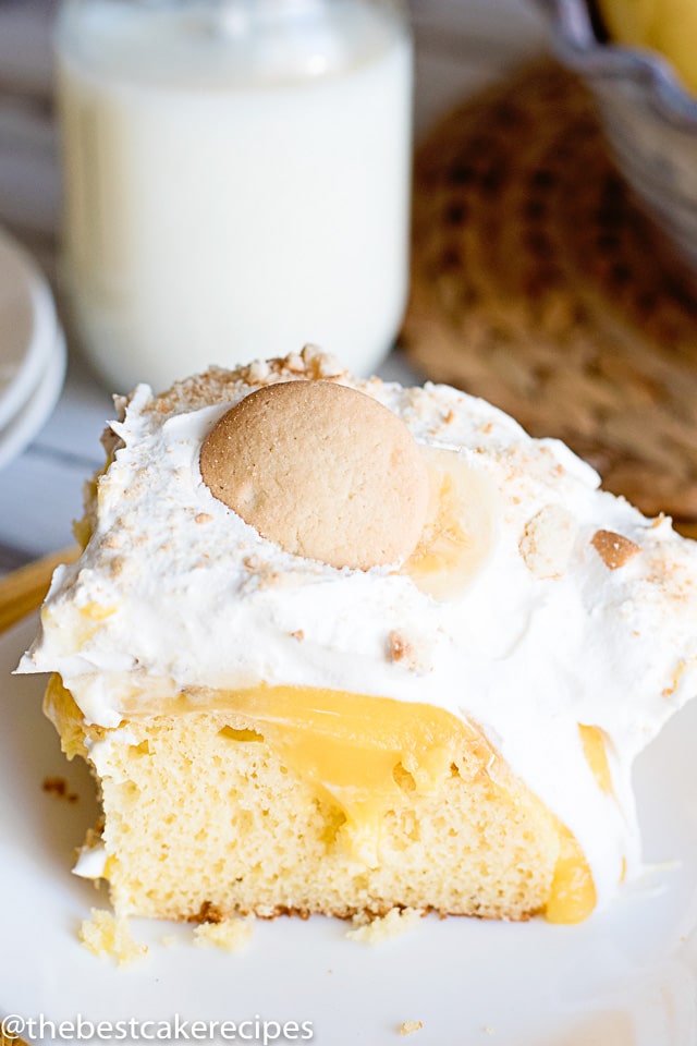 A piece of cake on a plate, with bananas and pudding