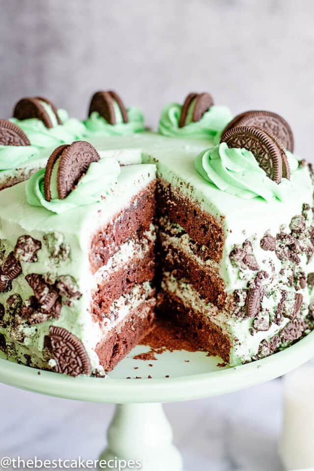 mint oreo layer cake with one slice missing