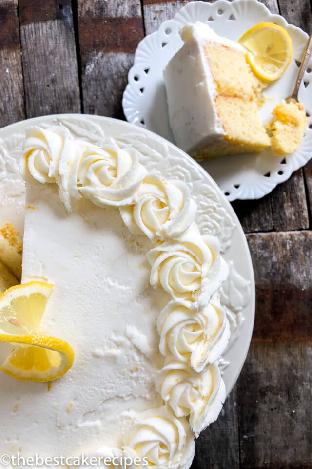 overhead view of lemon cake with one slice on a plate