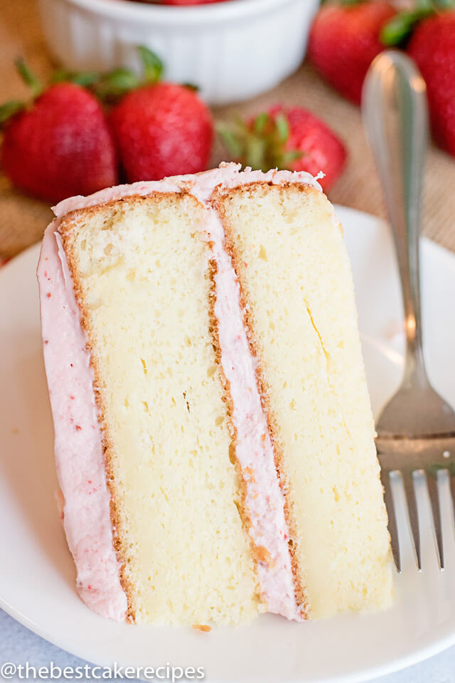 easy white cake with strawberry buttercream on a plate with a fork