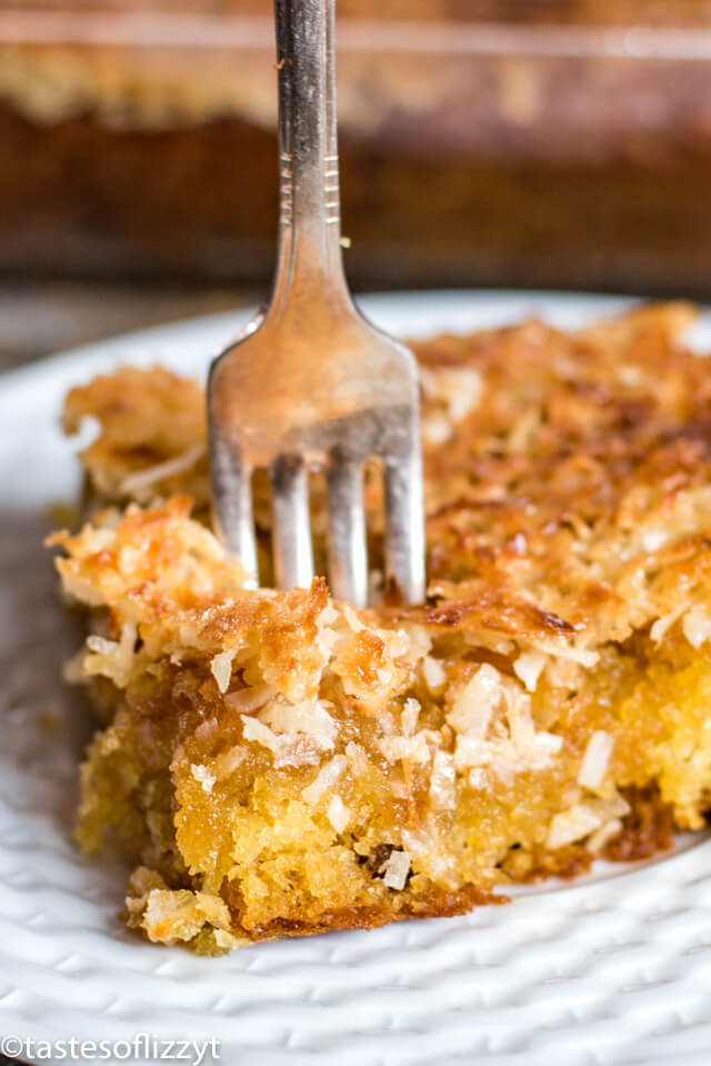 coffee cake with coconut topping on a plate with a fork