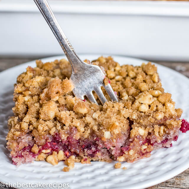 raspberry cake with streusel topping on a plate with fork