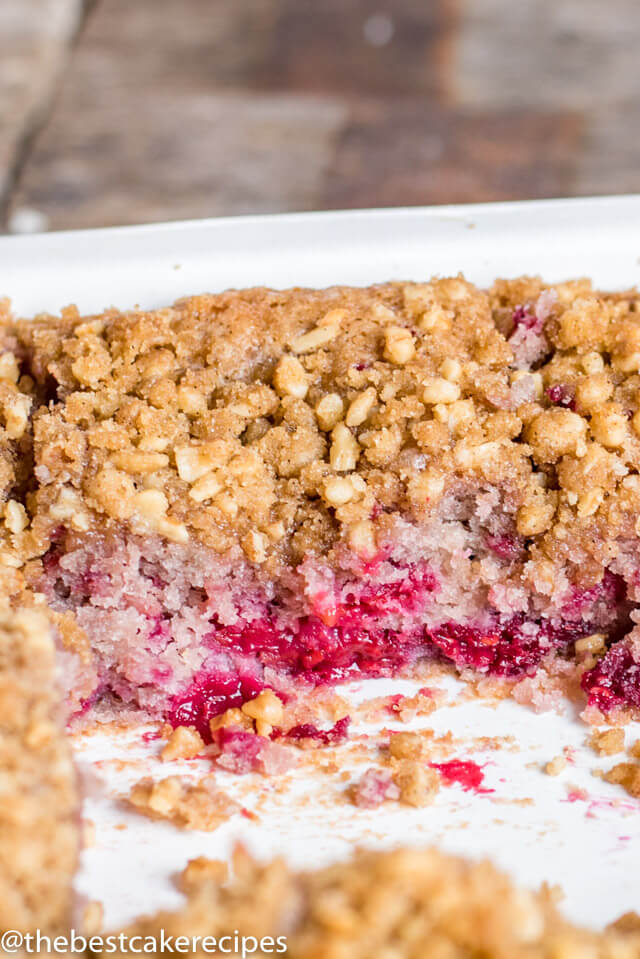 raspberry coffee cake in a baking pan with pieces missing
