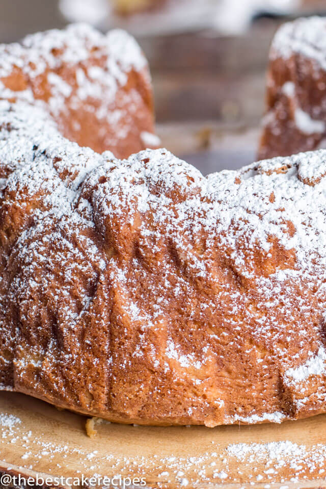 A close up of a piece of cake covered in powdered sugar