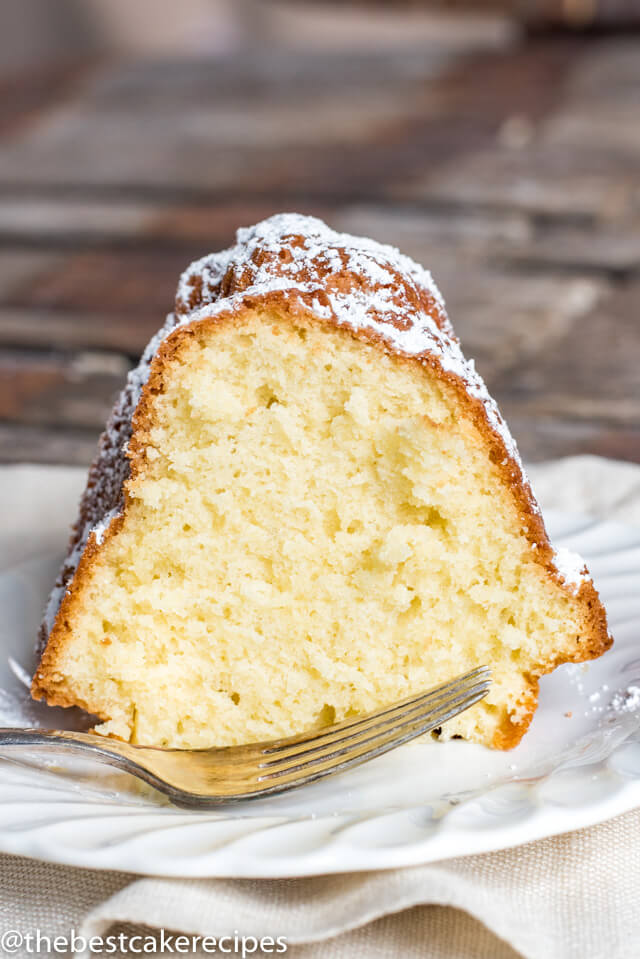 A piece of powdered sugar pound cake on a plate