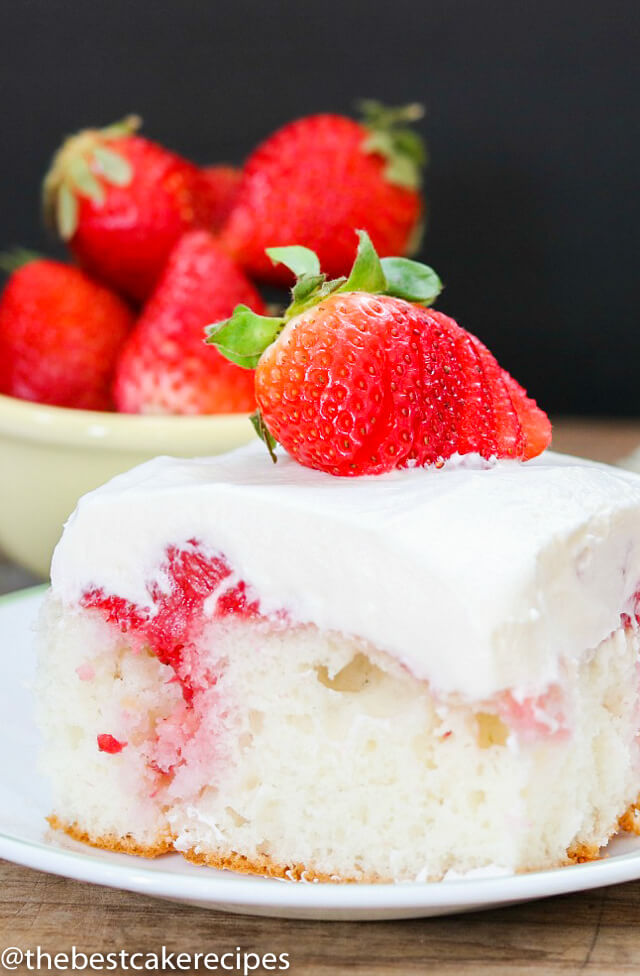A piece of cake on a plate, with Strawberries
