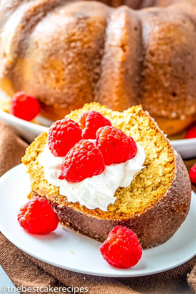 carve of bourbon cake on a plate with raspberries  Bourbon Cake Recipe bourbon cake recipe 3