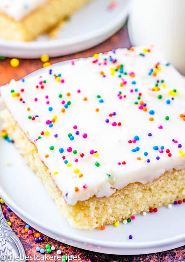 white cake with frosting and sprinkles