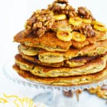 stack of pancakes with bananas and nuts