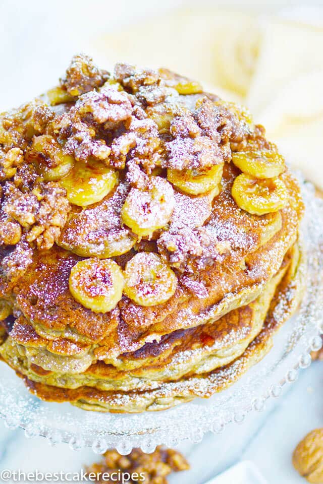 stack of pancakes with bananas and nuts