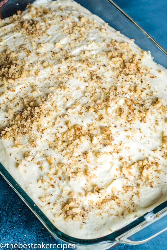 frosted cake with walnuts in a baking pan