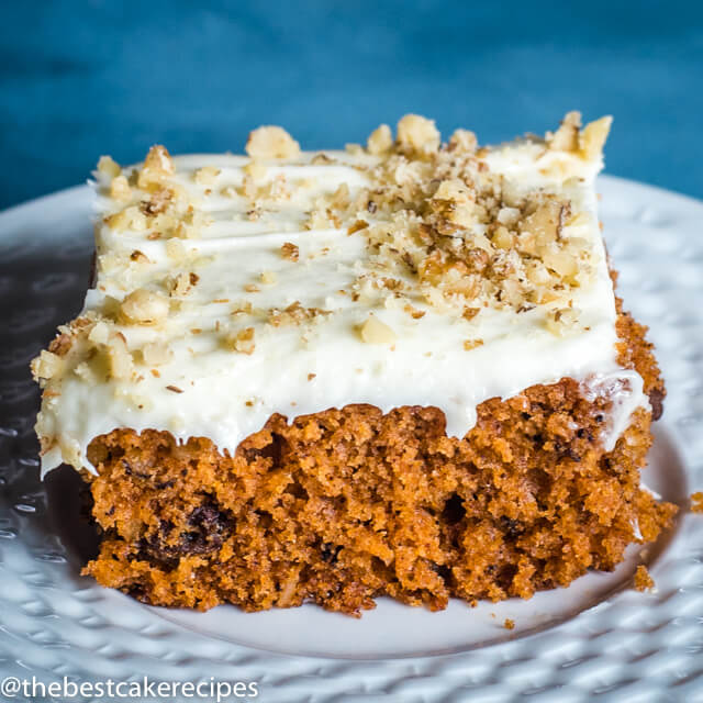 piece of spice cake with nuts and frosting on a plate