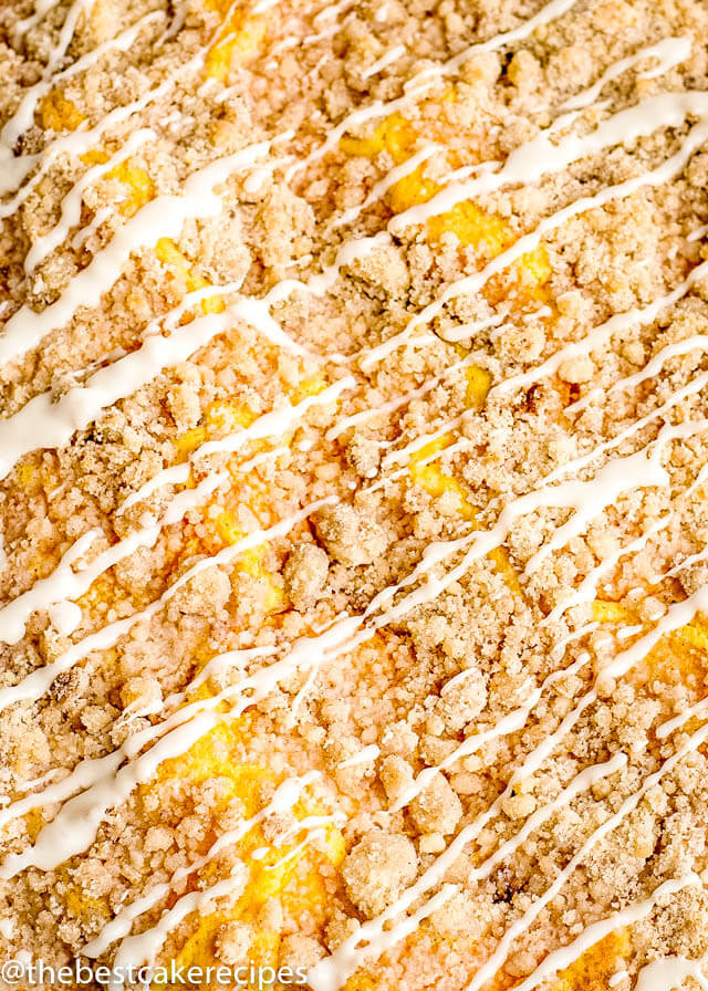 top of a Peach Crumb Cake drizzled with glaze