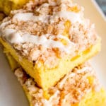 Peach Crumb Cake with fresh peaches on a plate