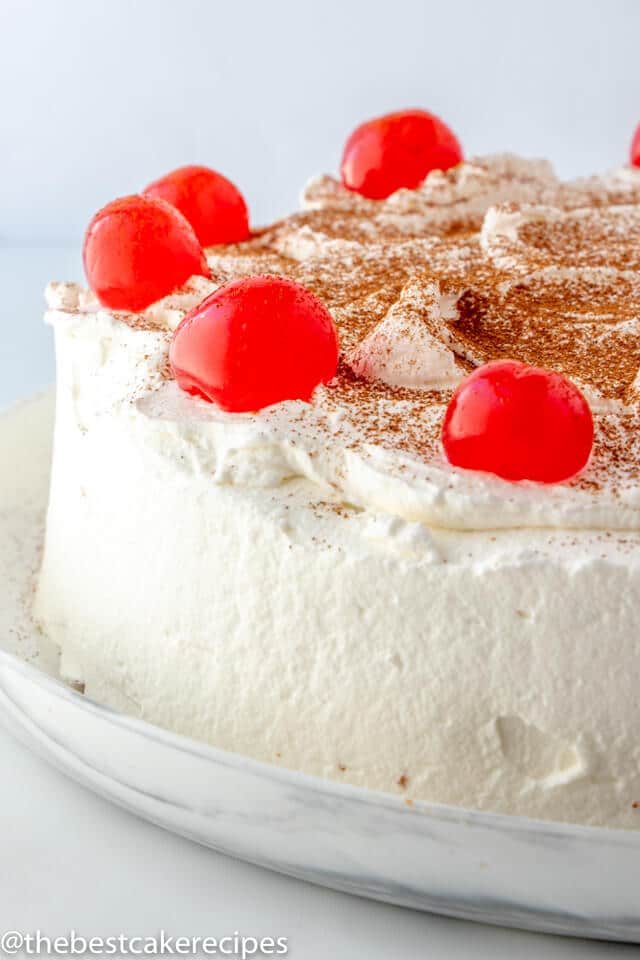 whole uncut Tres Leches Cake with cherries