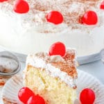 Tres Leches Cake on a plate with cherries