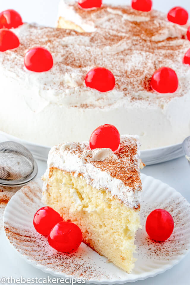 Tres Leches Cake on a plate with cherries