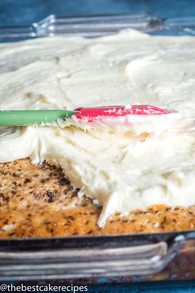 cream cheese frosting spreading on a cake