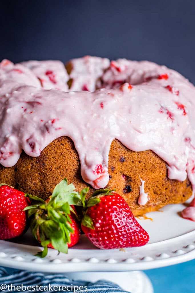 Strawberry Bundt Cake with glaze on a cake plate