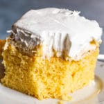 Pineapple Cream Cake on a plate with bite out of it
