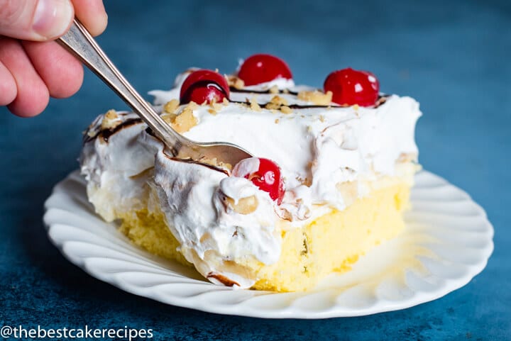 A piece of cake on a paper plate, with a fork