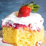 Strawberry Pudding Cake with pudding and strawberries on a plate