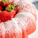 Filled Strawberry Bundt Cake with fresh strawberries on a plate