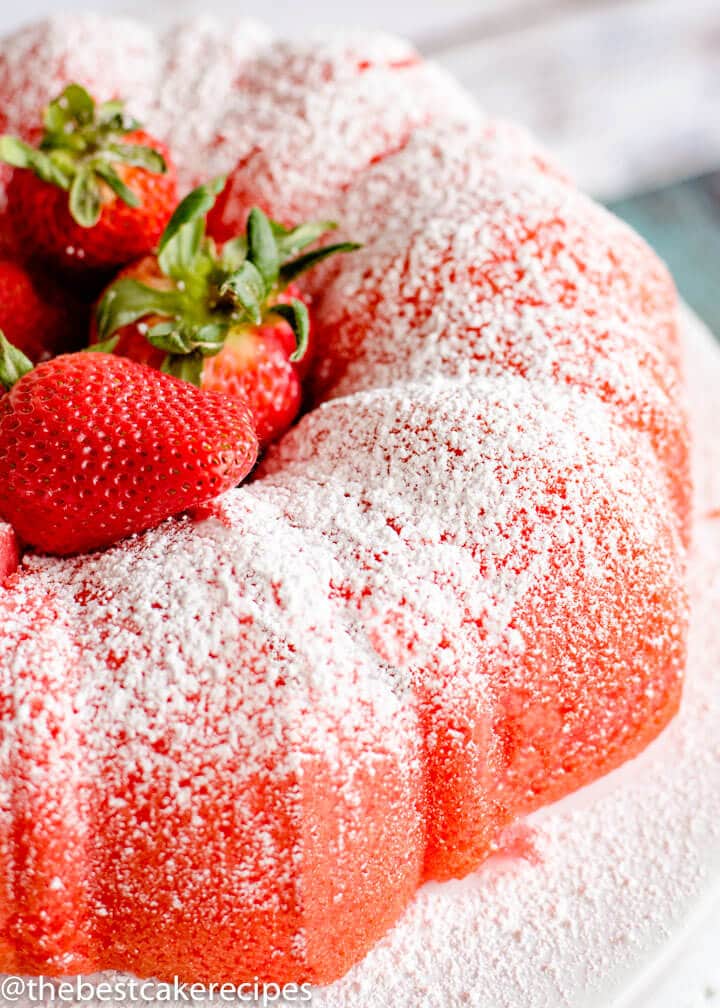 Filled Strawberry Bundt Cake with fresh strawberries on a plate