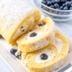sliced yellow cake roll with blueberries
