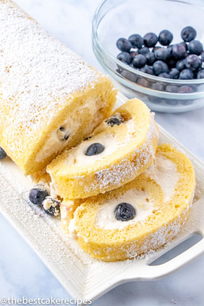 sliced yellow cake roll with blueberries