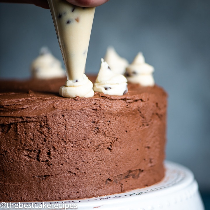 piping frosting on chocolate cake