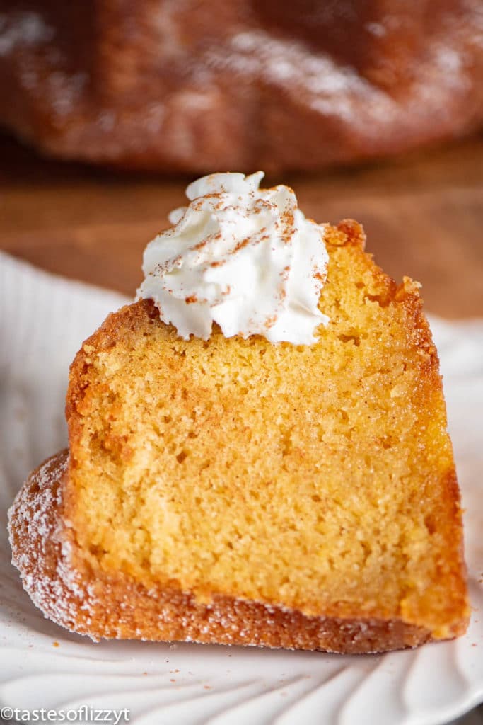 White Wine Cake on a plate with a dollop of whip cream