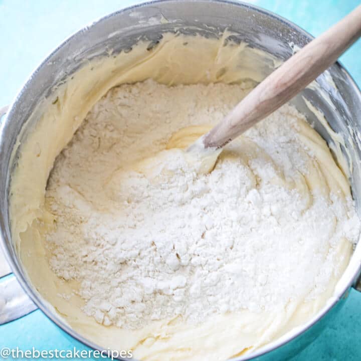 cake batter with flour on top in a mixing bowl