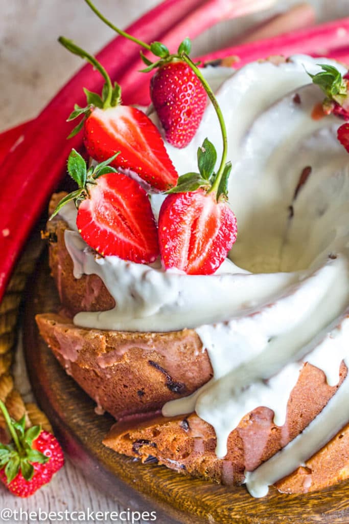 Strawberry Rhubarb Bundt Cake with glaze and strawberries