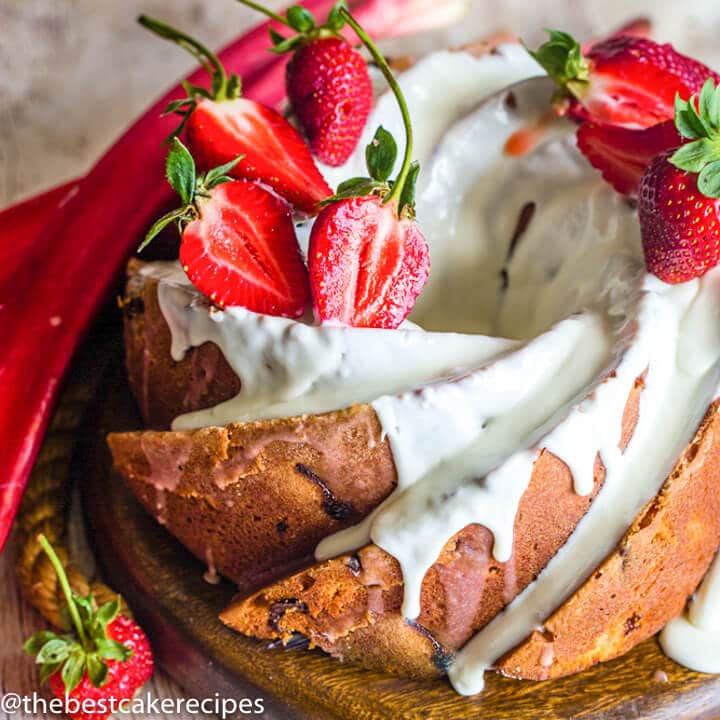 Strawberry Rhubarb Bundt Cake with glaze and strawberries on a plate