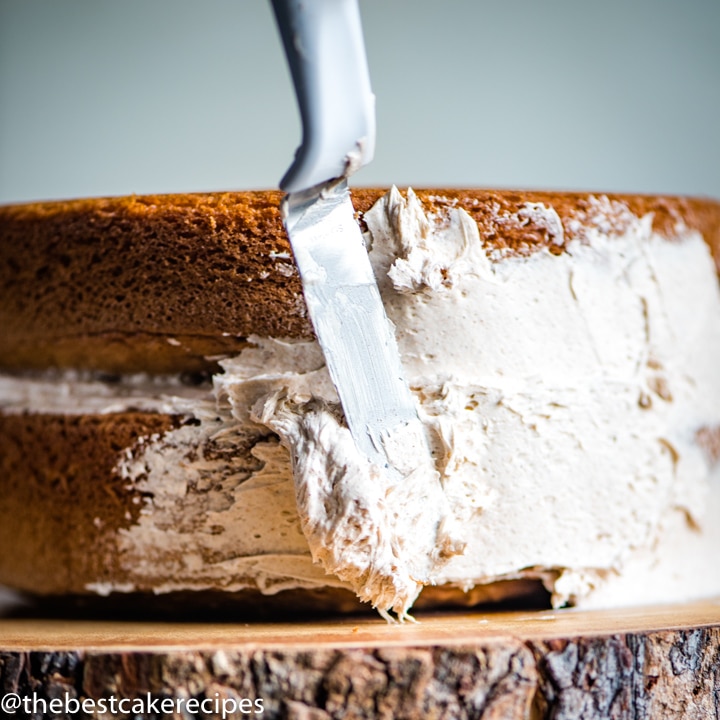 frosting a Cinnamon Layer Cake Recipe with a spatula
