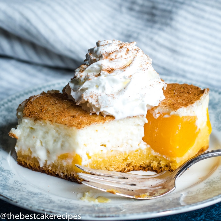 Peaches and Cream Cake on a plate with a bite out