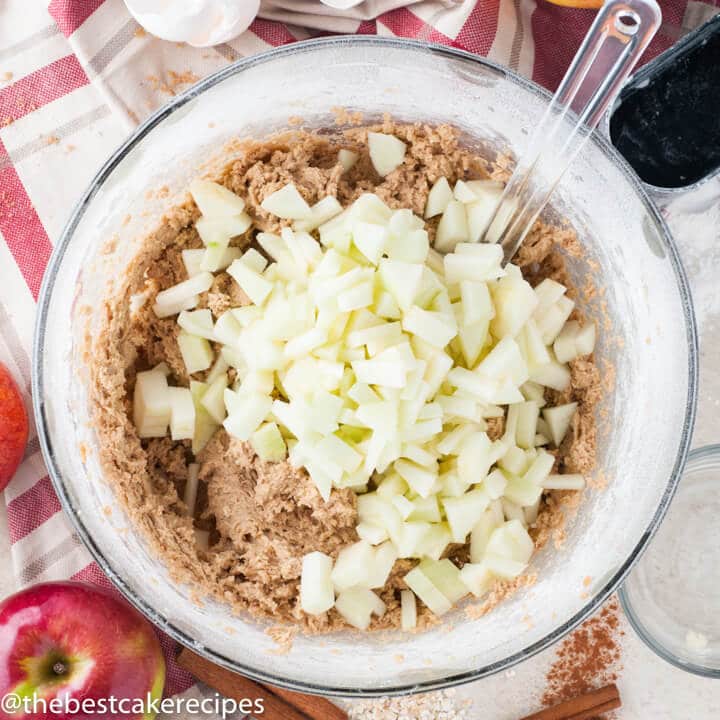 cake batter with chopped apples on top