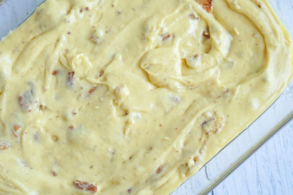 cake batter with pecans in a baking pan