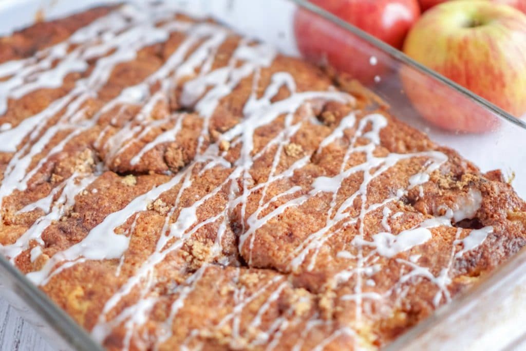 Apple Pie Cake with glaze in a baking pan