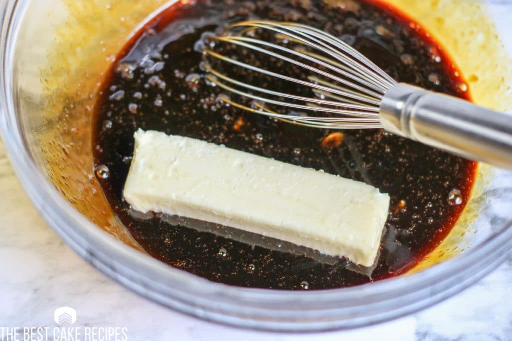molasses and butter in a bowl with a whisk