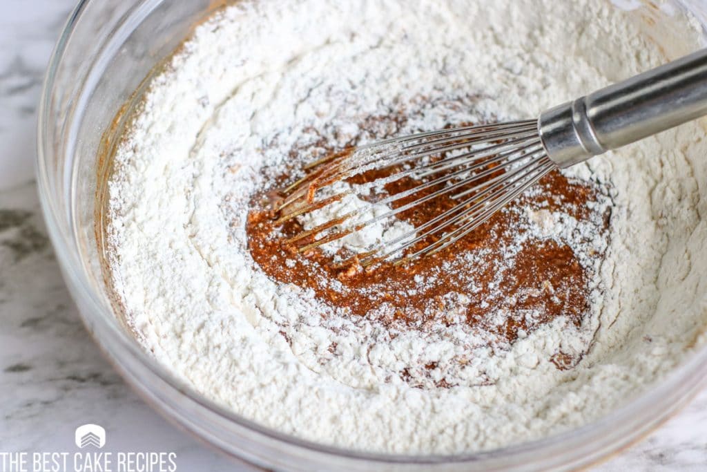 mixing flour into wet ingredients in a bowl