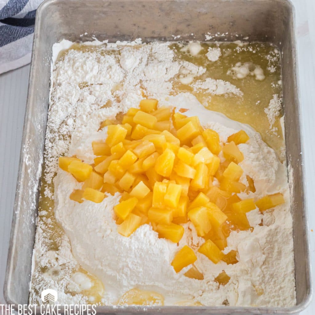 cake batter with pineapple in a baking pan