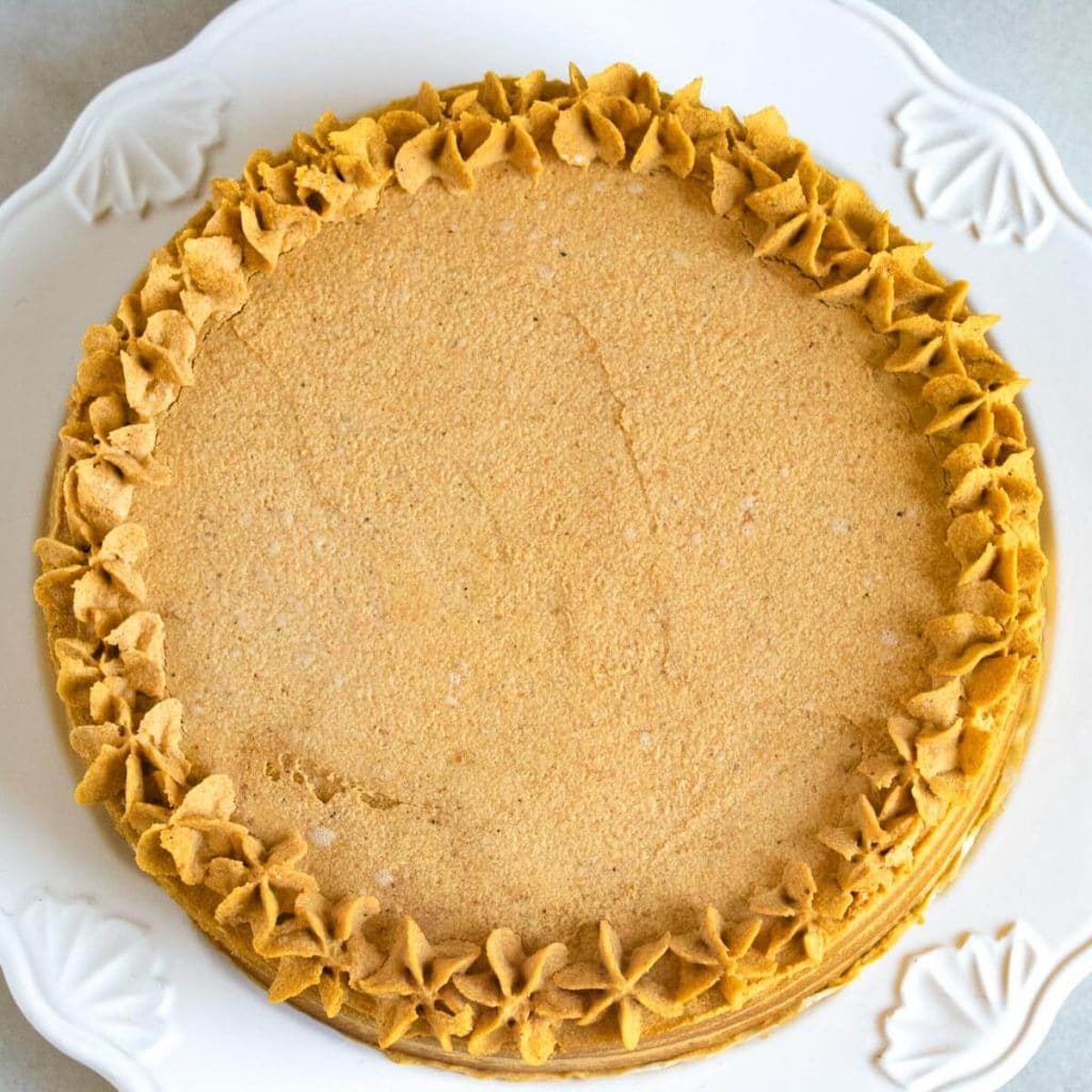 overhead pumpkin cake view with frosting stars around edge