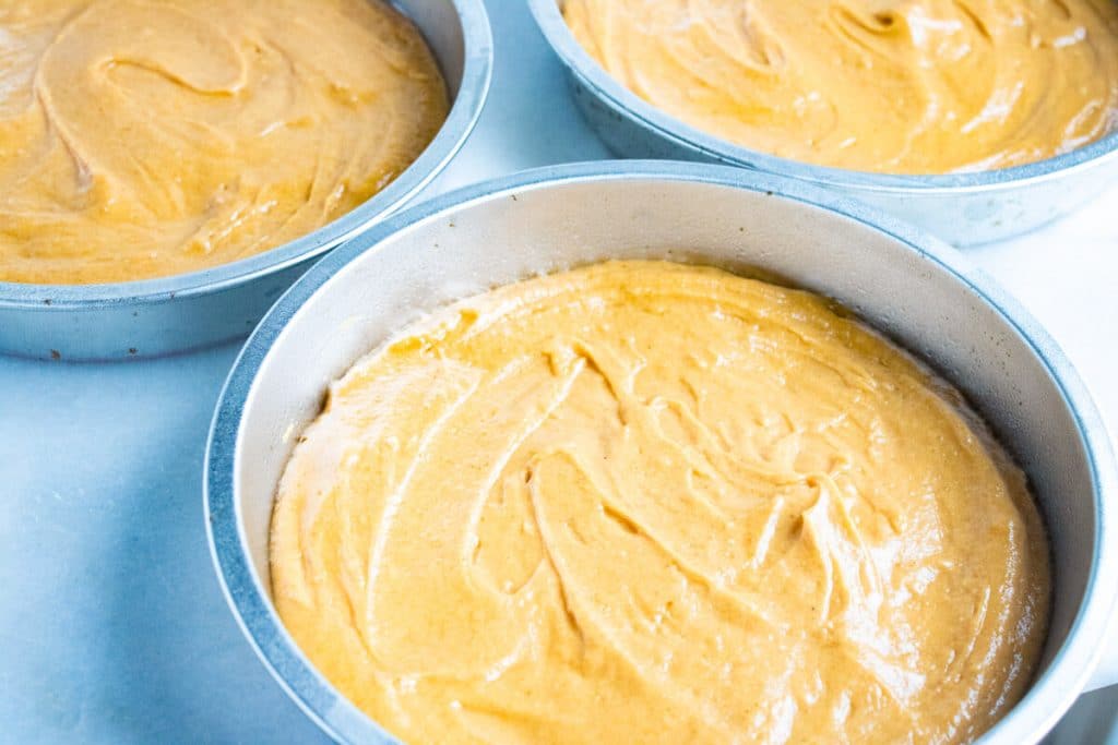 unbaked pumpkin cakes in pans